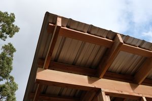 The roof metal from below, showing the supporting purlins and rafters