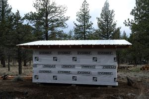 The back of the building wrapped in housewrap